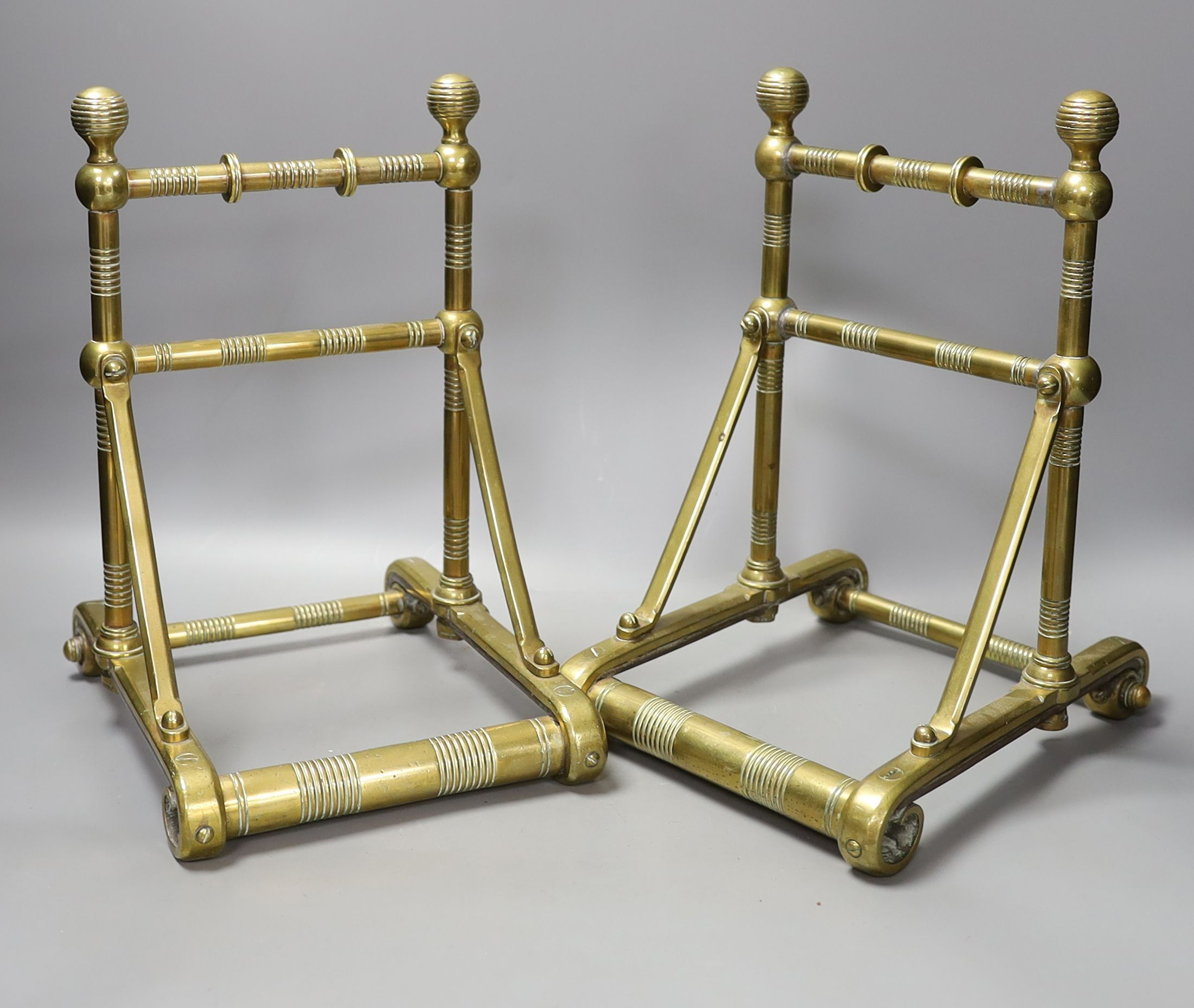 A pair of 19th century Dresser or Godwin style brass fire dogs